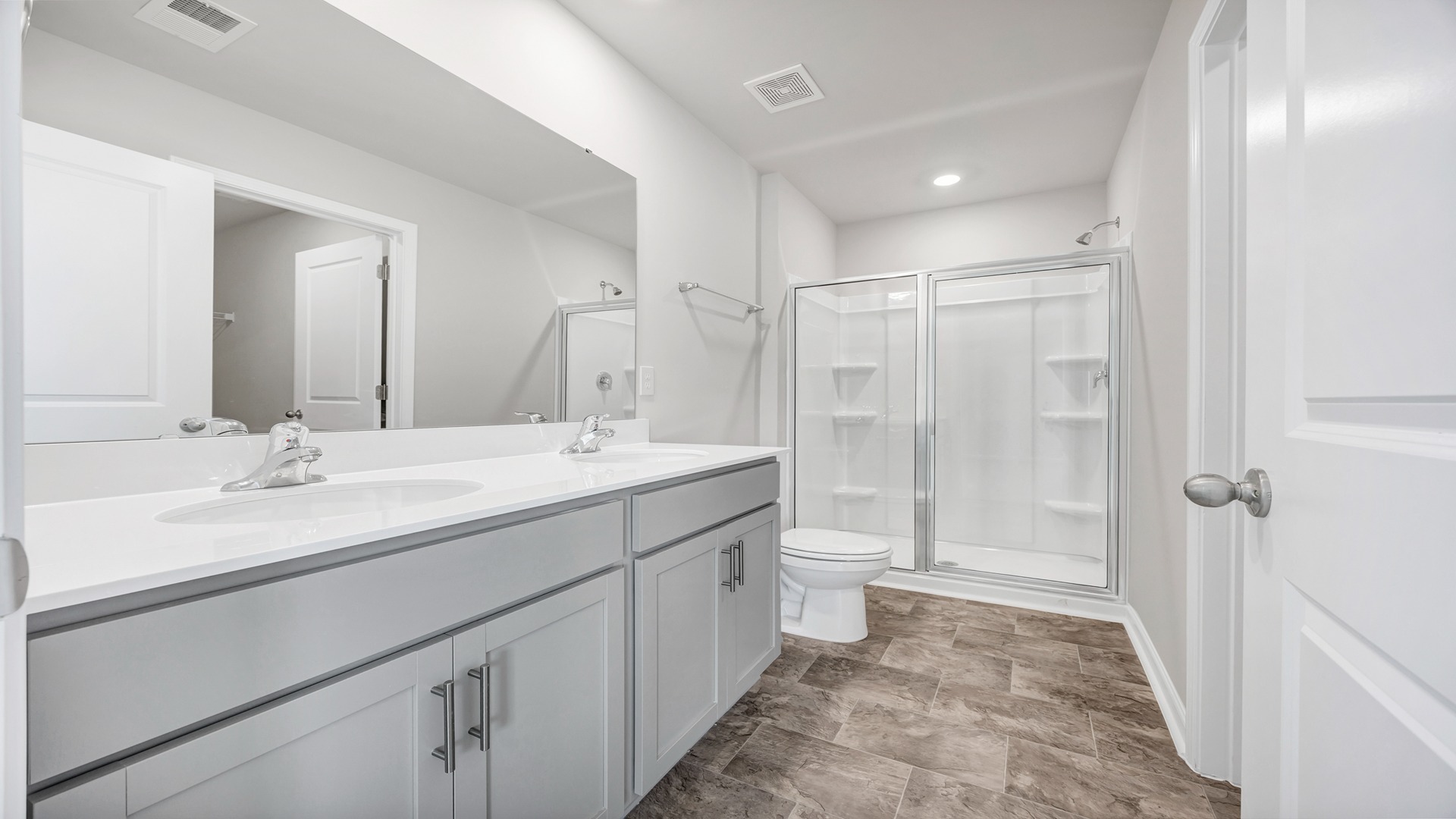 En-suite primary bathroom with a standup shower and double vanity