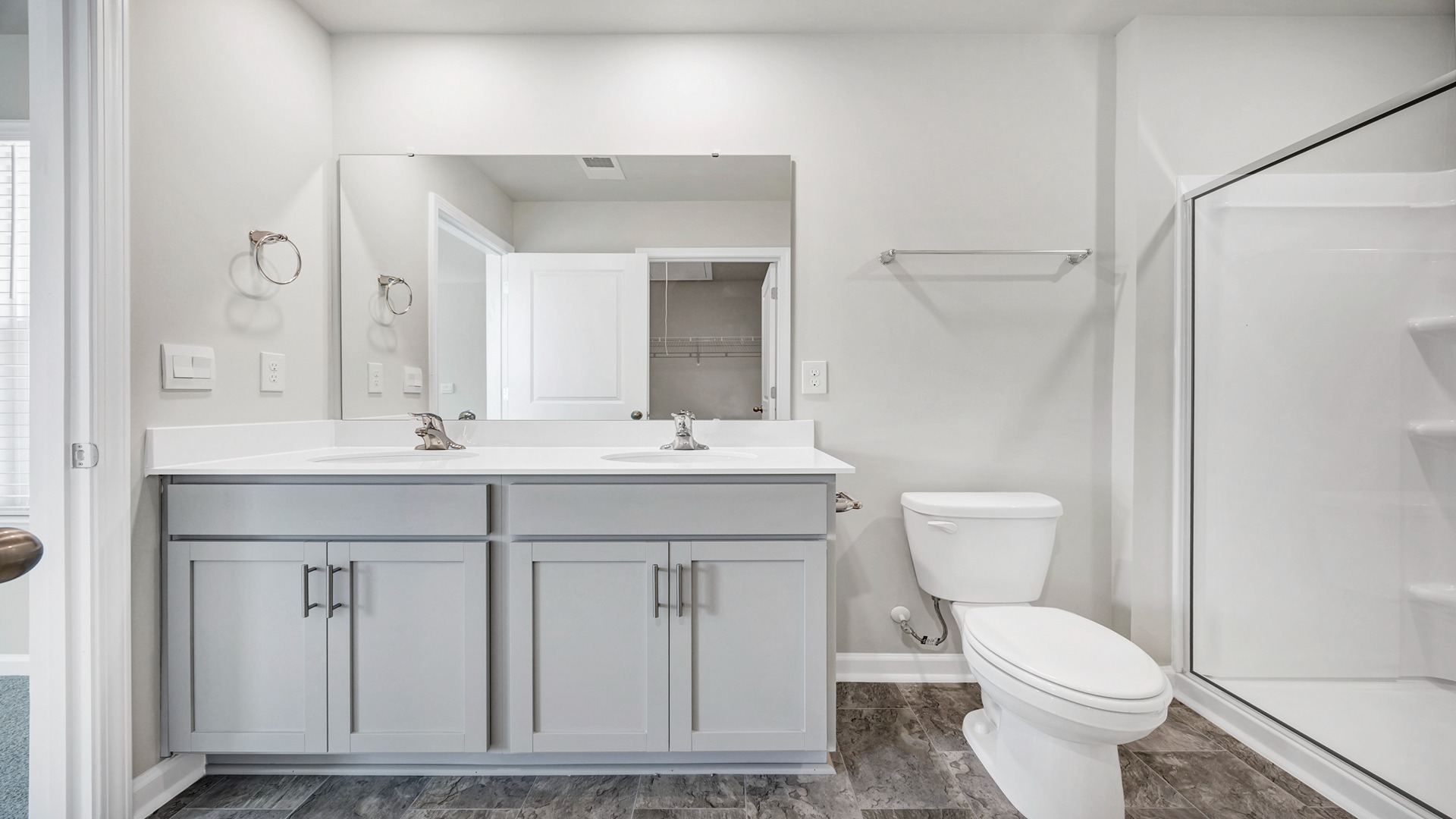 Double vanity with quartz countertops in the primary bathroom