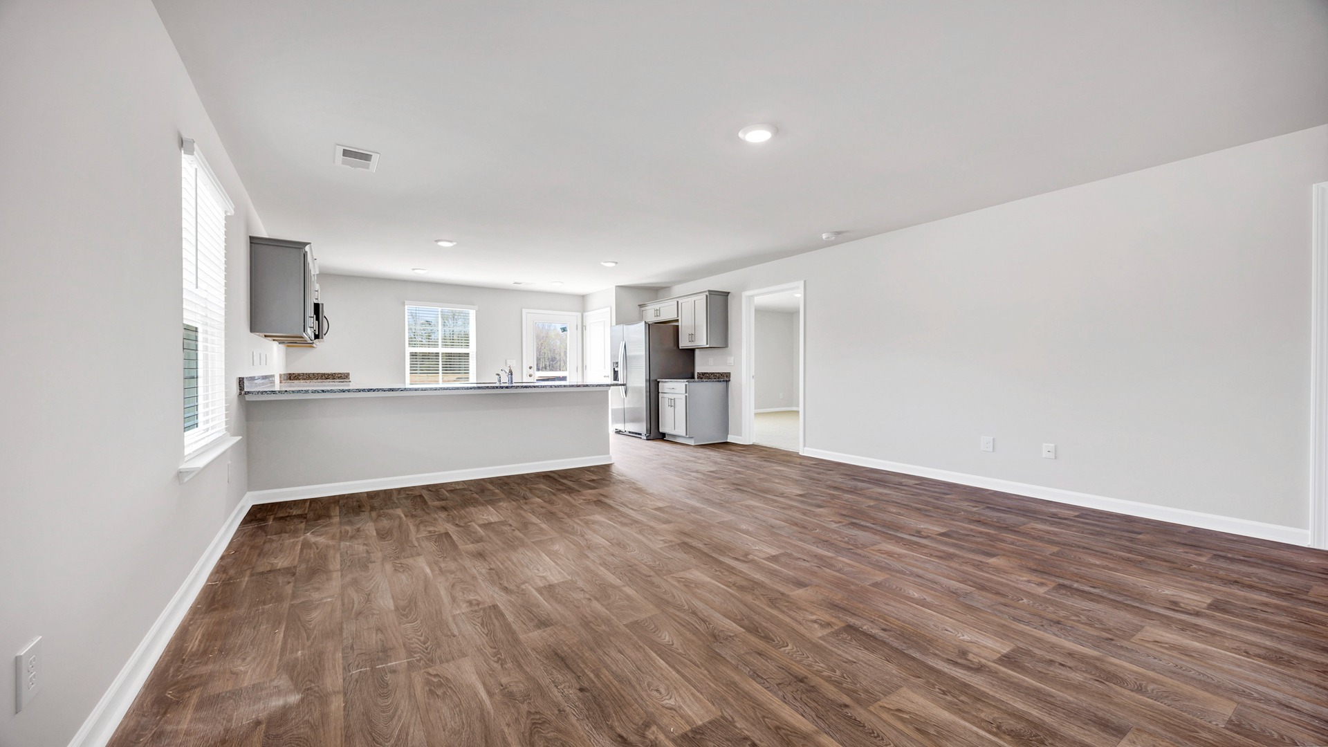 Vinyl flooring and neutral-colored paint finishes the main living areas