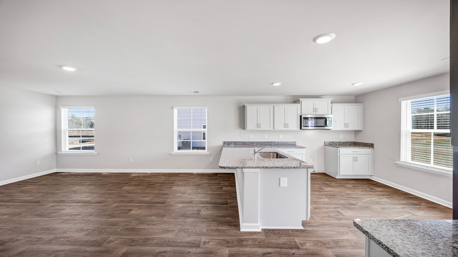 Kitchen bar overlooks the living area with space for barstool seating