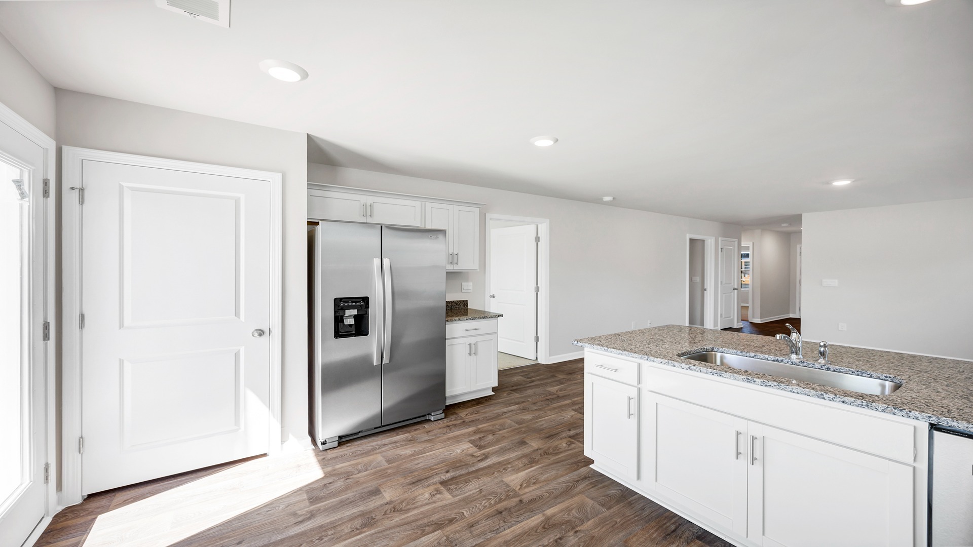 Modern kitchen in new construction home will have white quartz countertops