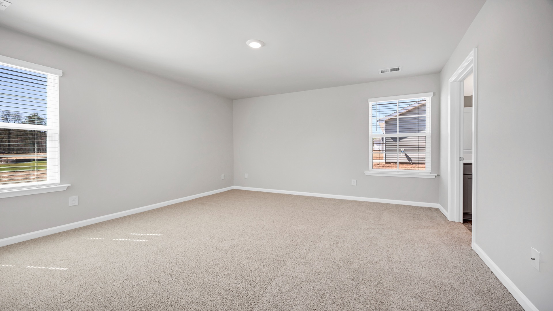 Primary bedroom with natural light from two windows