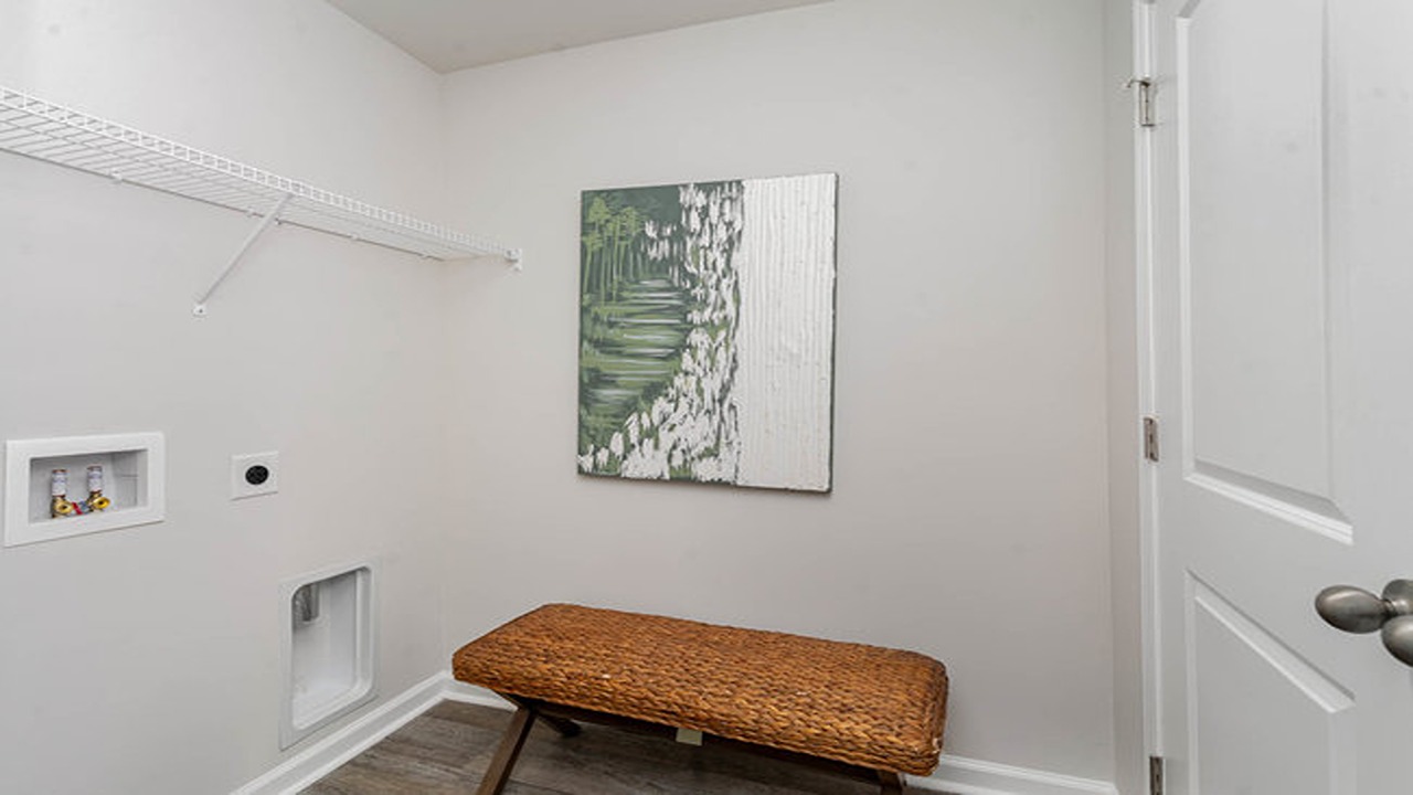 The laundry room is centrally located in the home.