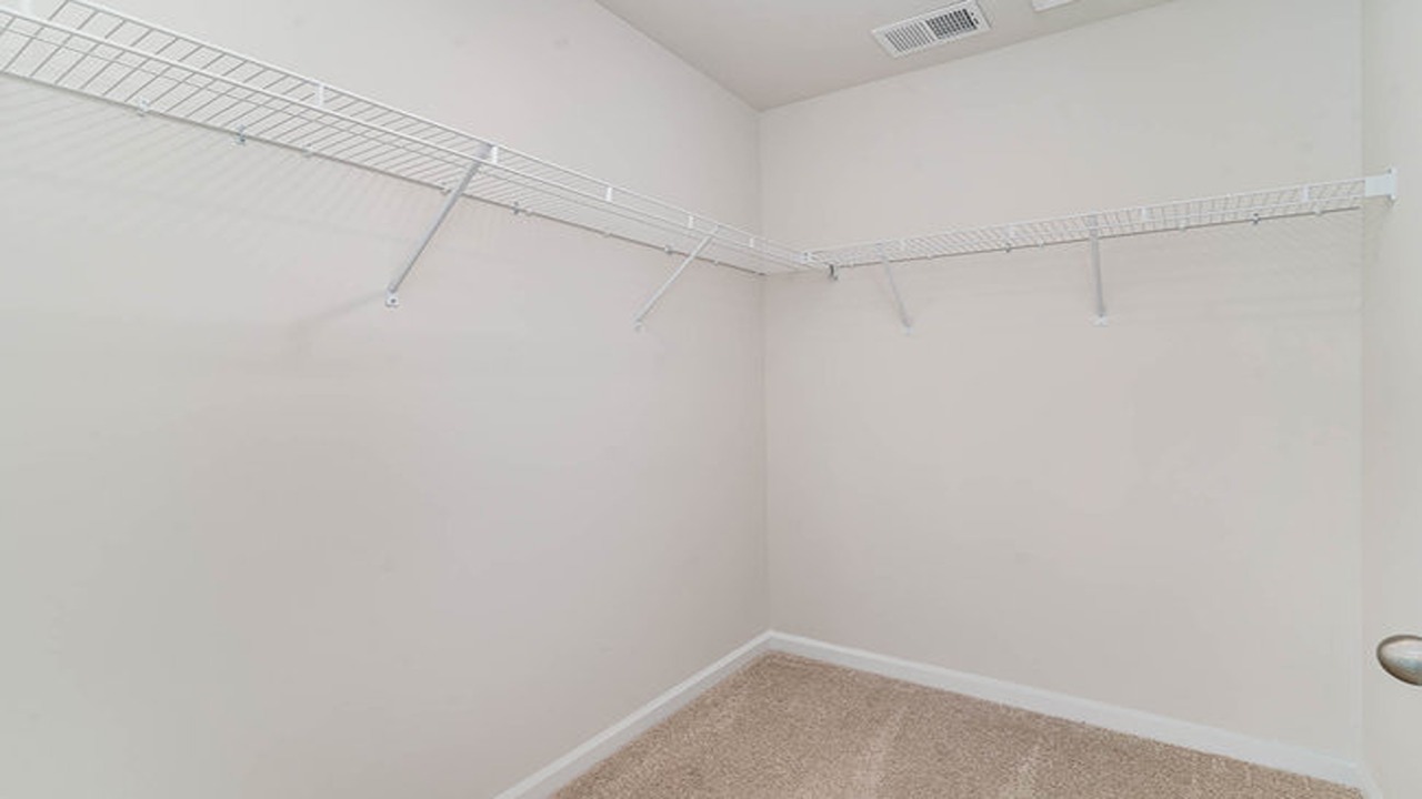 The primary closet is carpeted and walk-in.