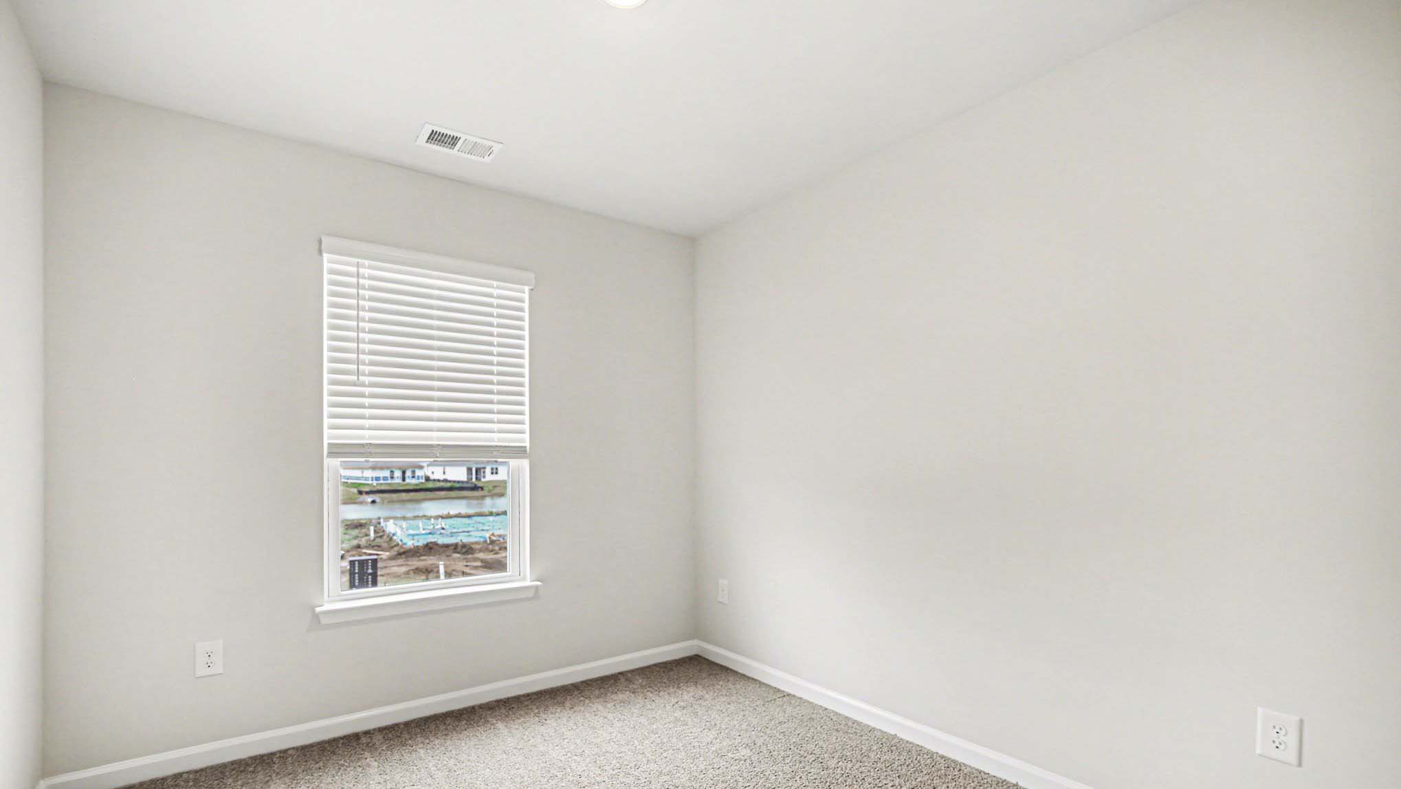 Bedroom 2 upstairs with a front facing window and carpet floors