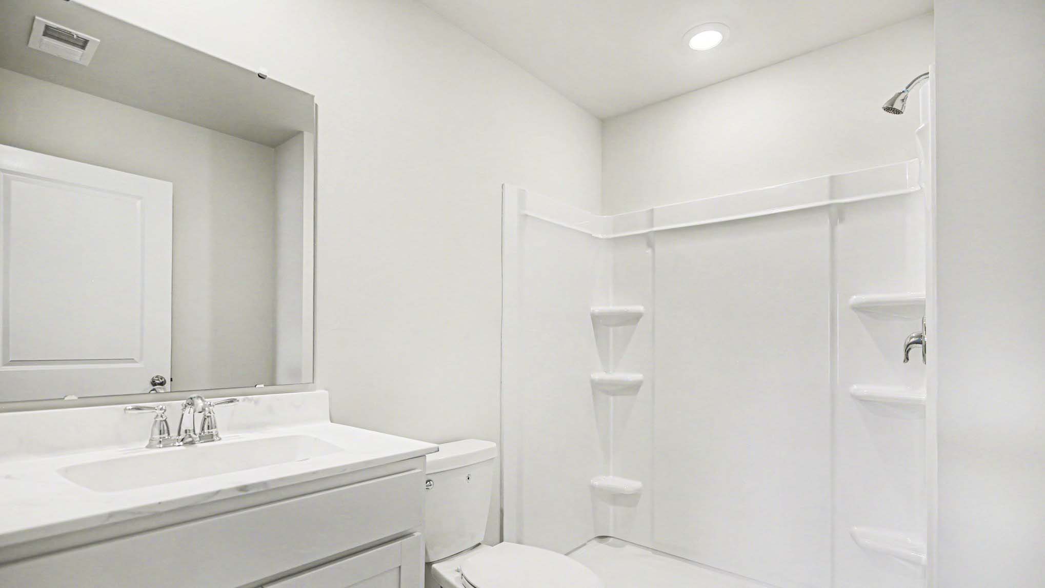 En-suite primary bathroom with white quartz countertops