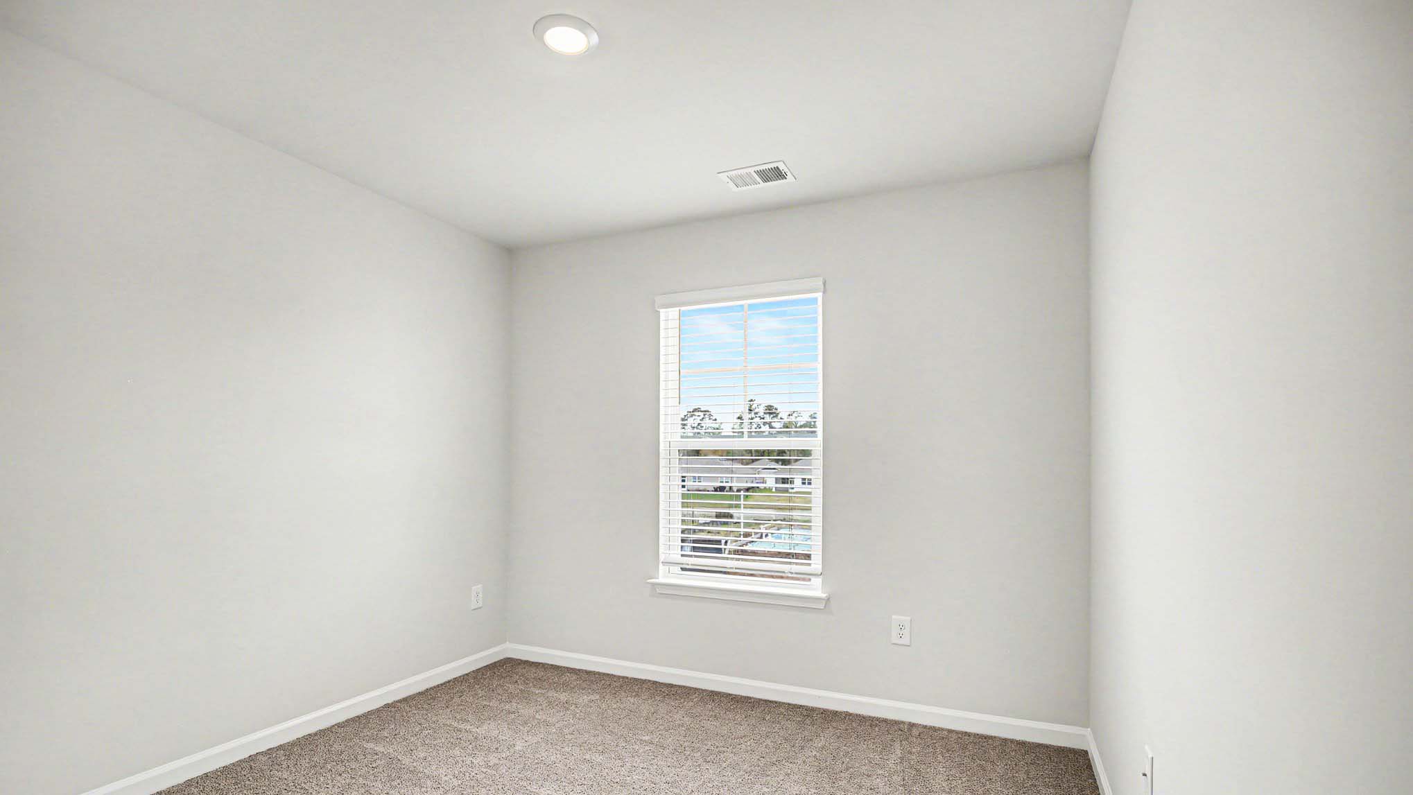 Bedroom 3 upstairs with carpet flooring and a window for light
