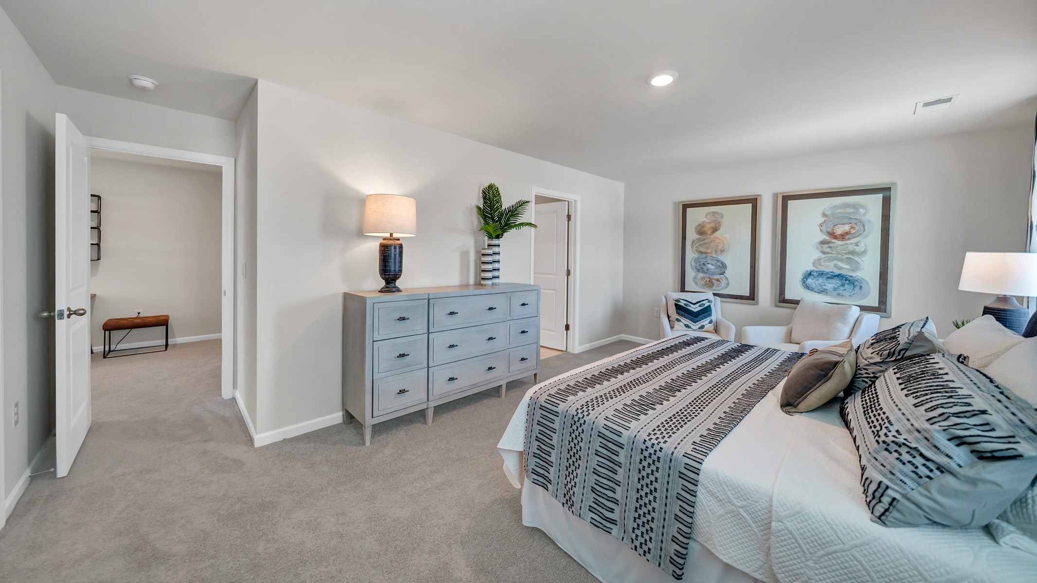 Upstairs primary bedroom with carpet flooring