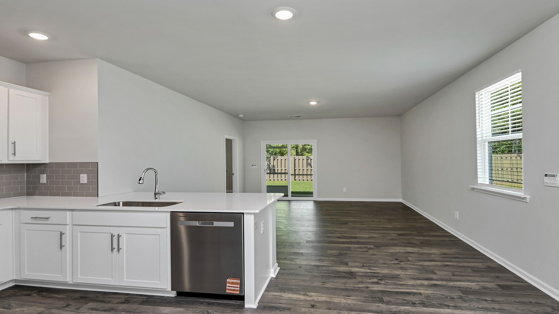 Kitchen bar overlooks the open living area of home for sale in Ferry Grove