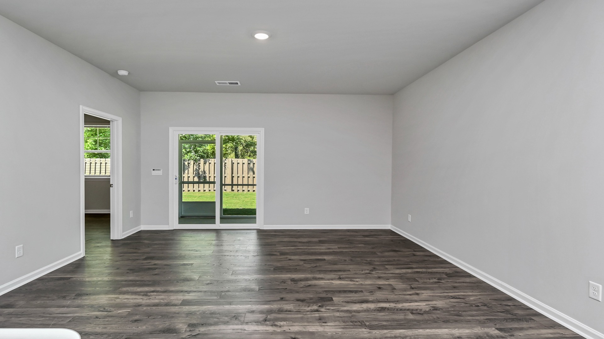 Spacious living area in new construction home in Lexington, SC with natural light and vinyl floors