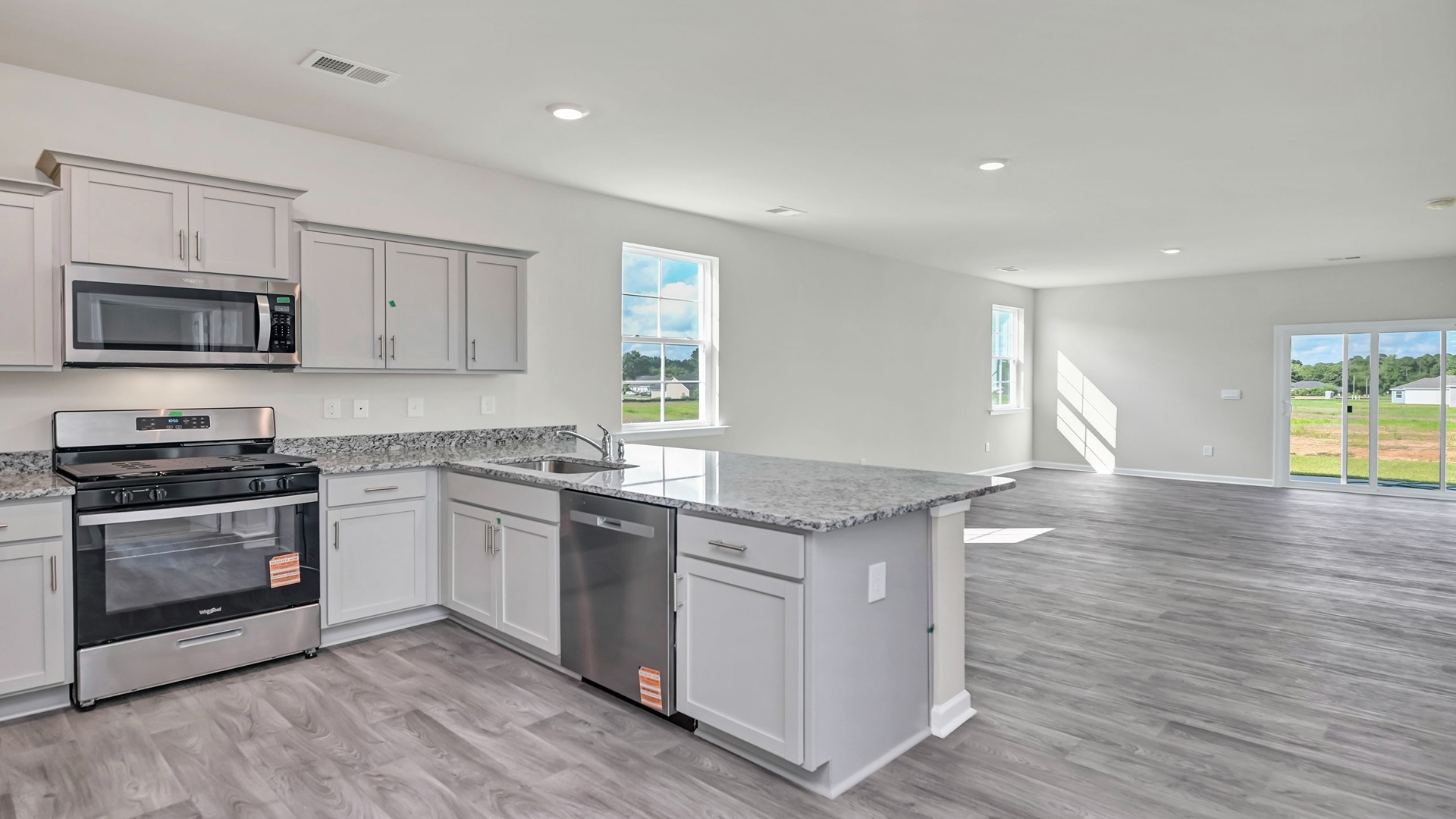 Kitchen bar overlooks the dining and living areas