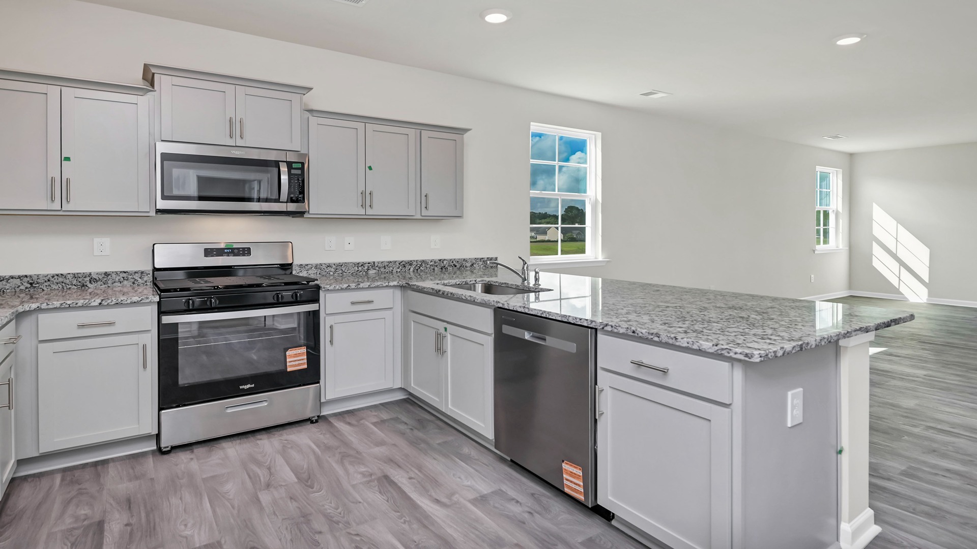Kitchen bar overlooks the dining and living areas