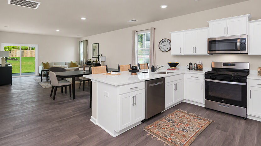 Kitchen bar overlooks the open concept dining and living areas