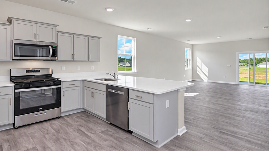 Kitchen bar overlooks the dining and living areas of the Cameron floor plan in Ferry Grove