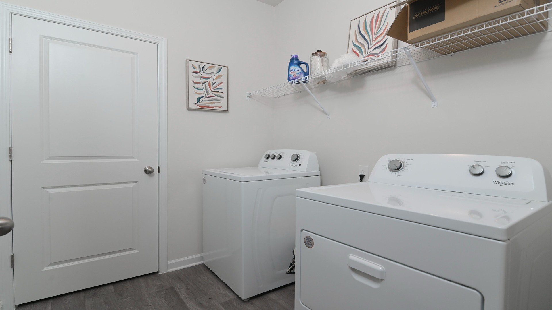 Centrally located laundry room with wire shelving above