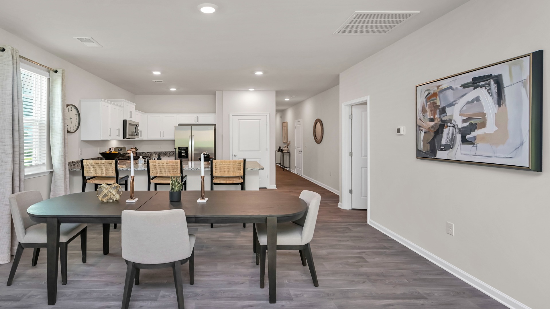 Open concept dining and kitchen areas in available home in Ferry Grove with matching vinyl floors