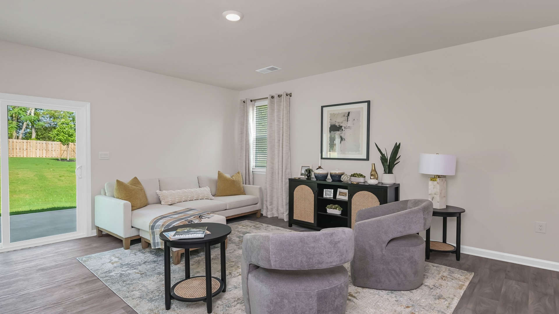 Glass sliding doors in the living area leads to the paved back patio