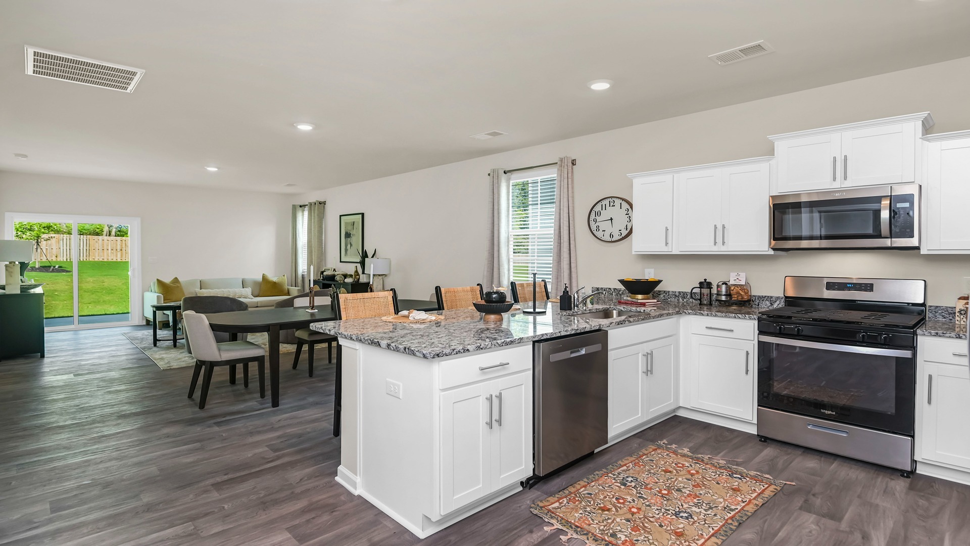 The kitchen bar looks the dining and living areas