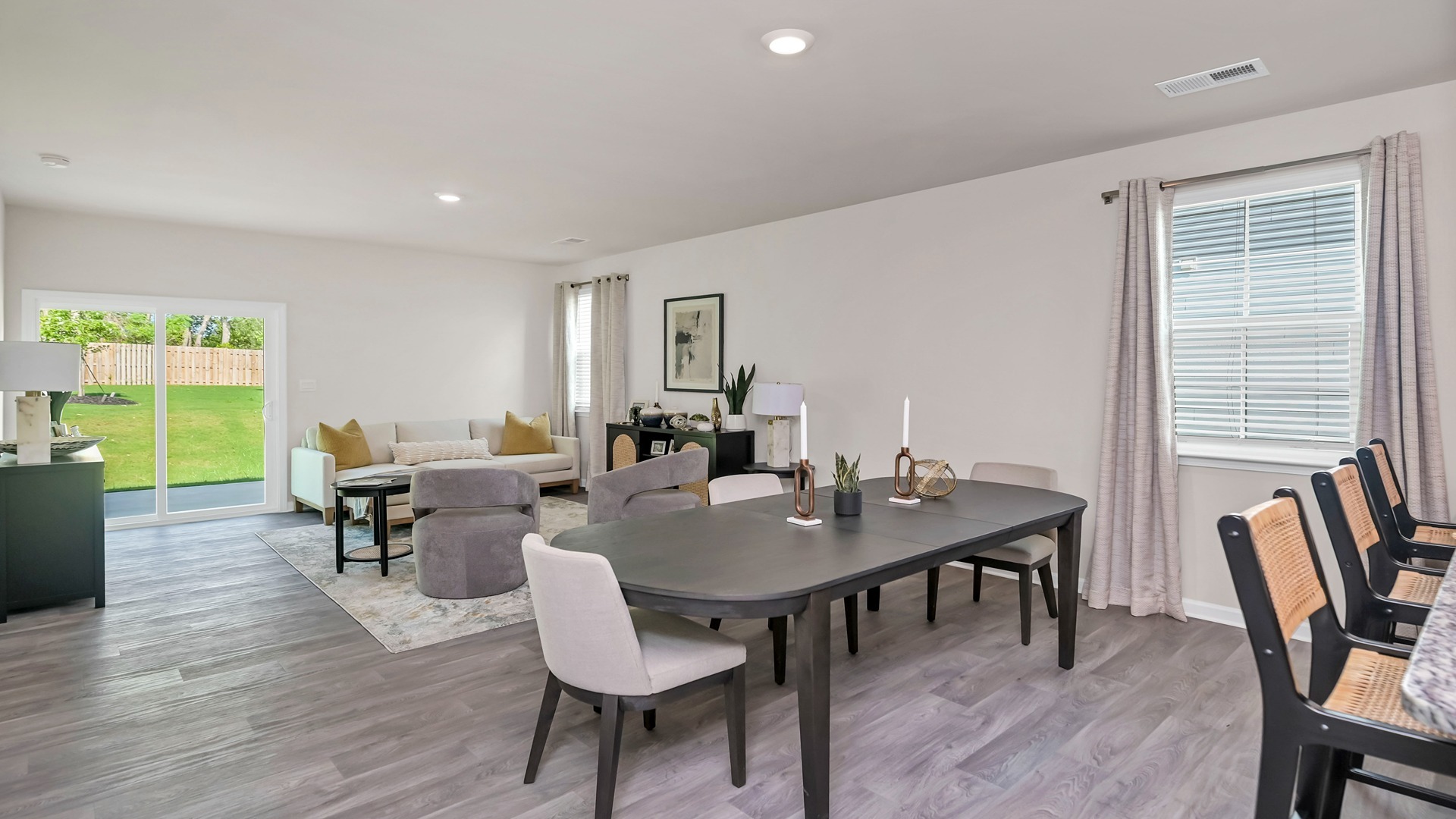 The dining and living areas are open concept with several windows.