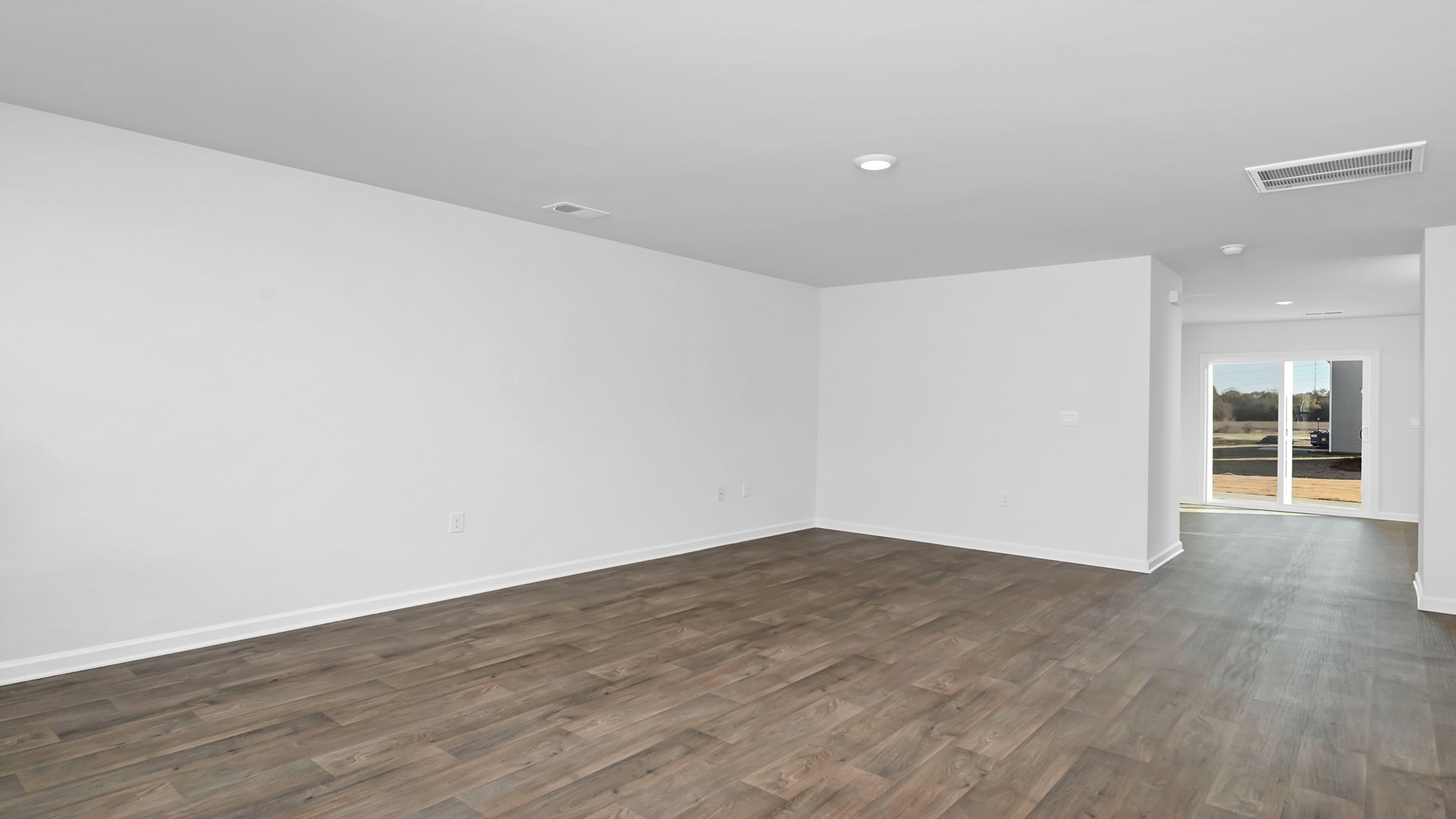 Spacious living area leads into the dining and kitchen spaces