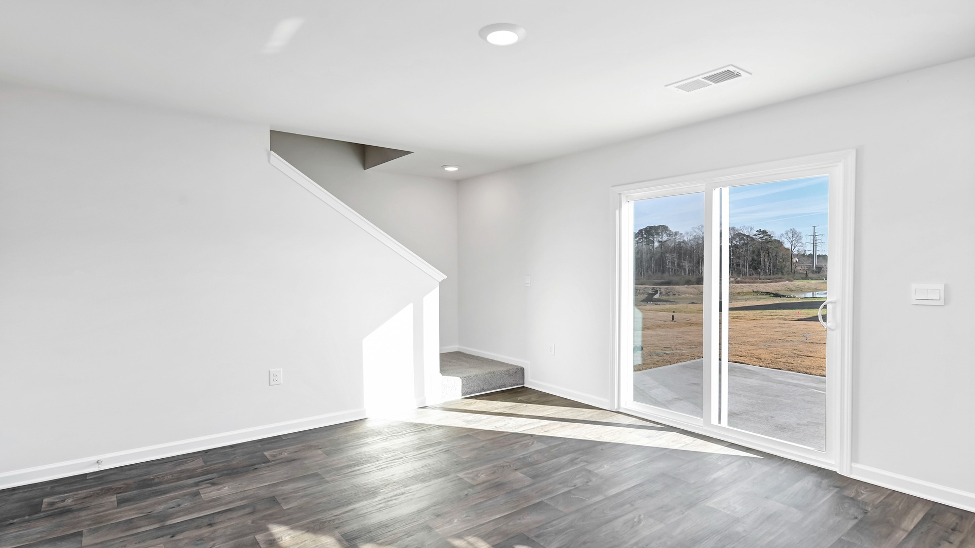 Dining area with back glass sliding doors that leads to paved back patio