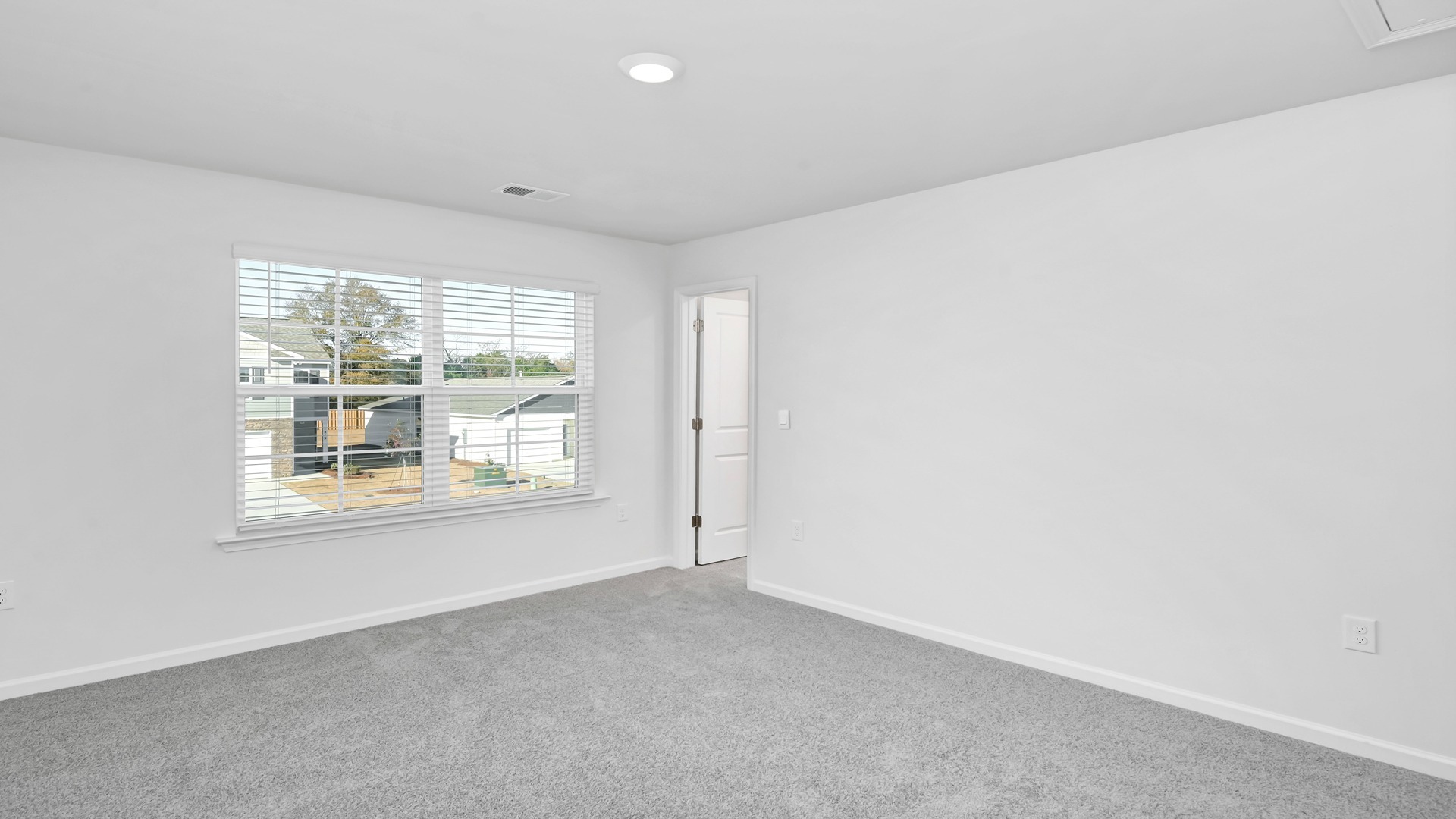 Bedroom 3 upstairs with a walk-in closet and carpet flooring