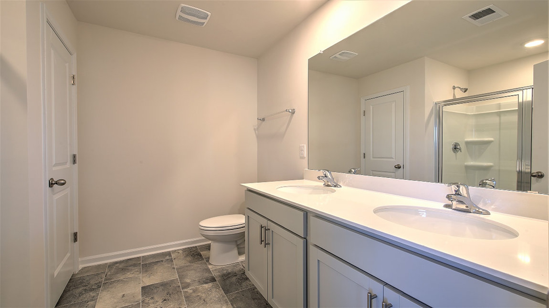 En-suite primary bathroom with double vanity