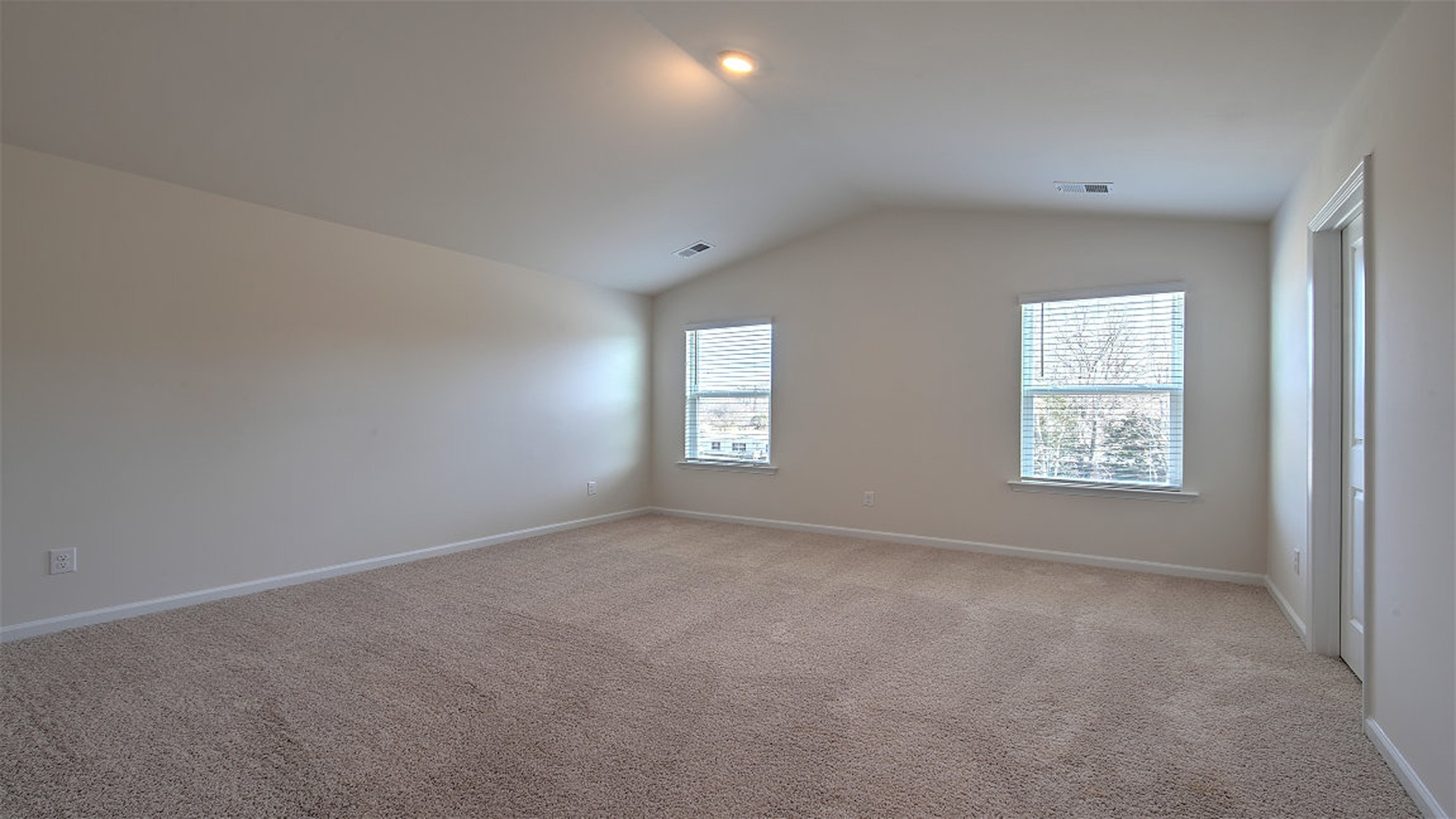 Primary bedroom with several window for light
