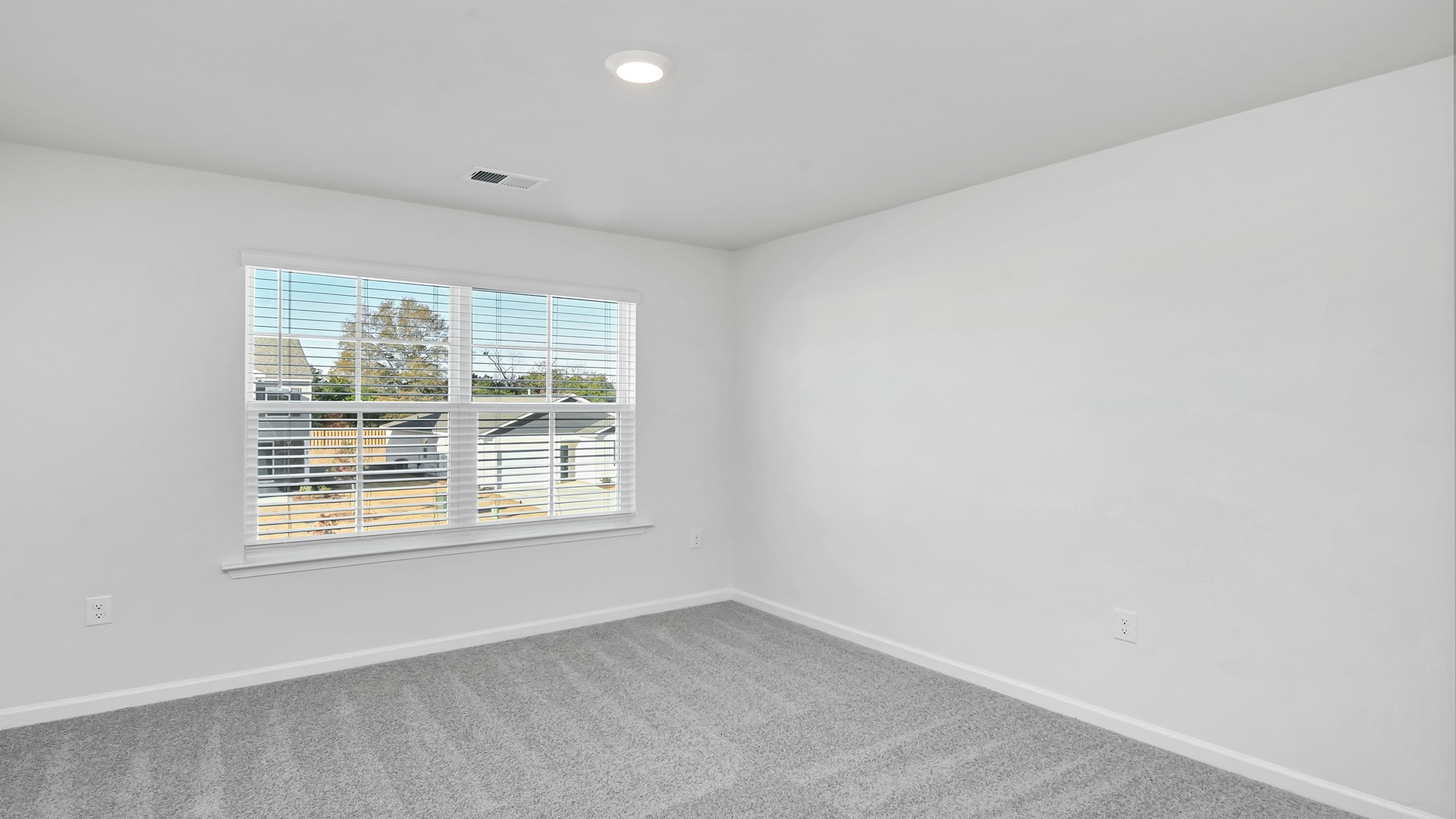 bedroom 2 with a large window and carpet flooring