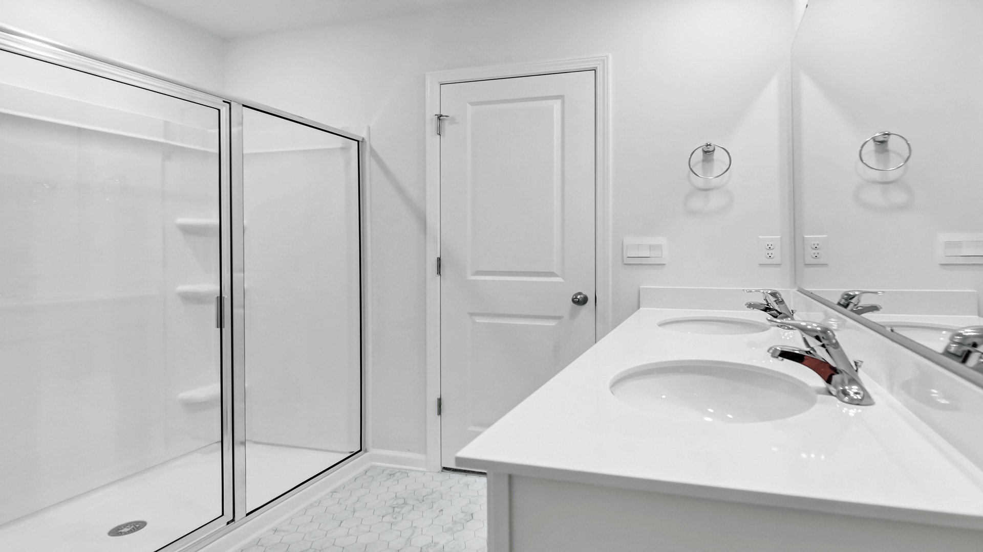 Standup shower with glass doors in the bathroom