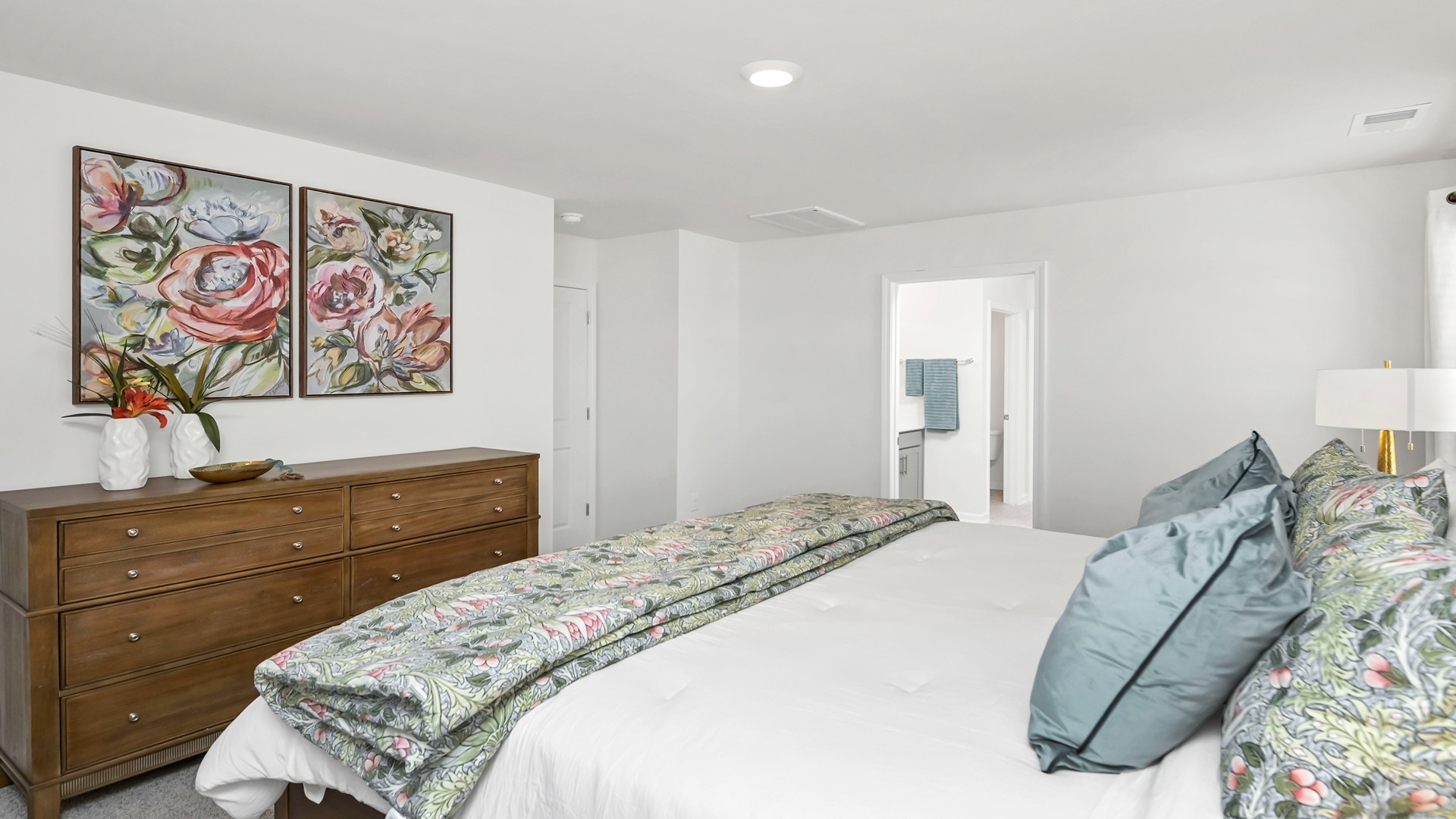 Primary bedroom with several windows and carpet flooring
