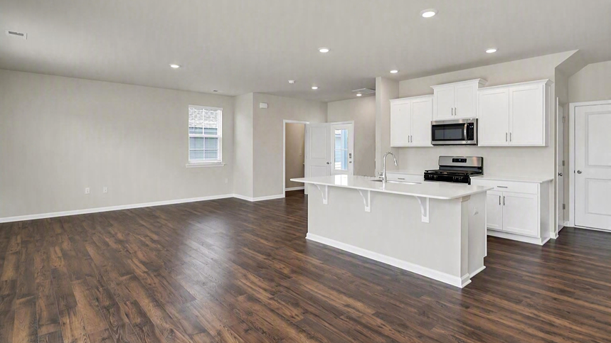 Open-concept main level living and kitchen space in the Aisle floor plan for sale