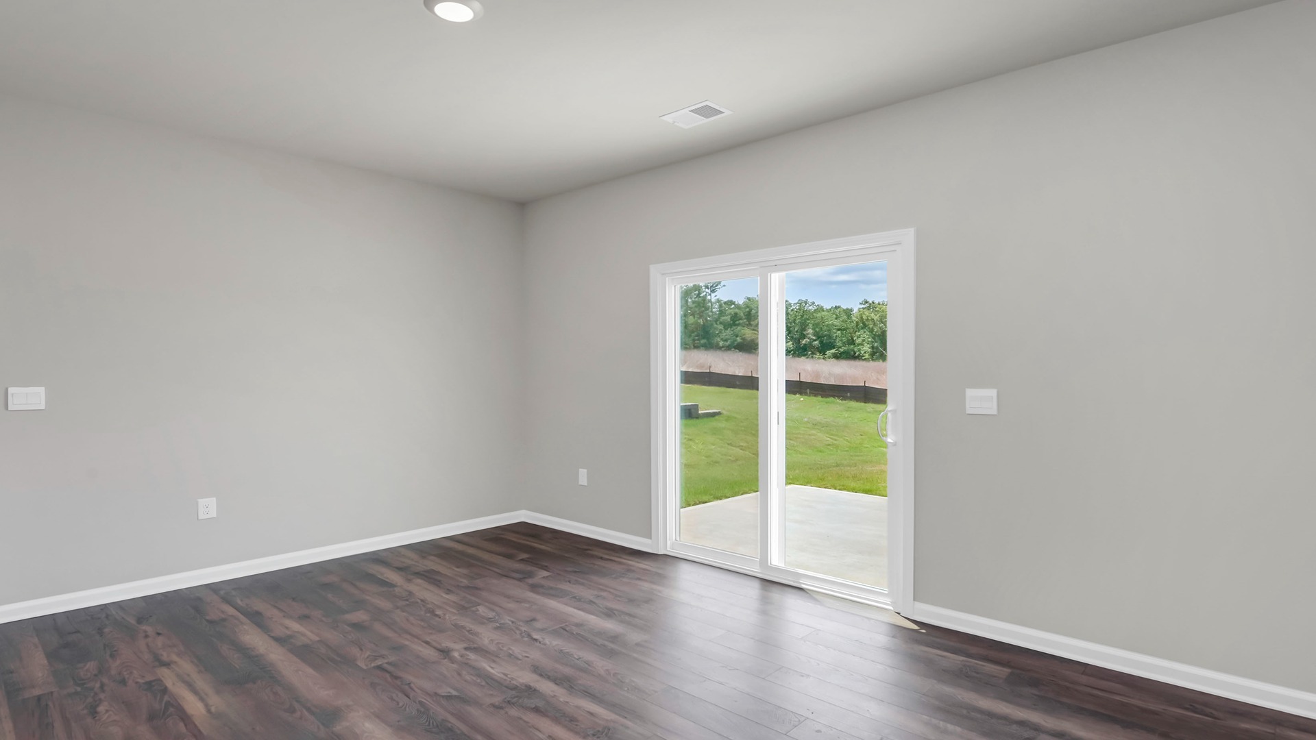 Dining area with access to the paved back patio through back glass sliding doors