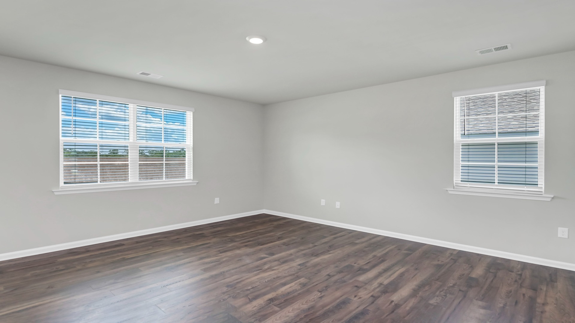 Living area with several windows and woodgrain vinyl floor