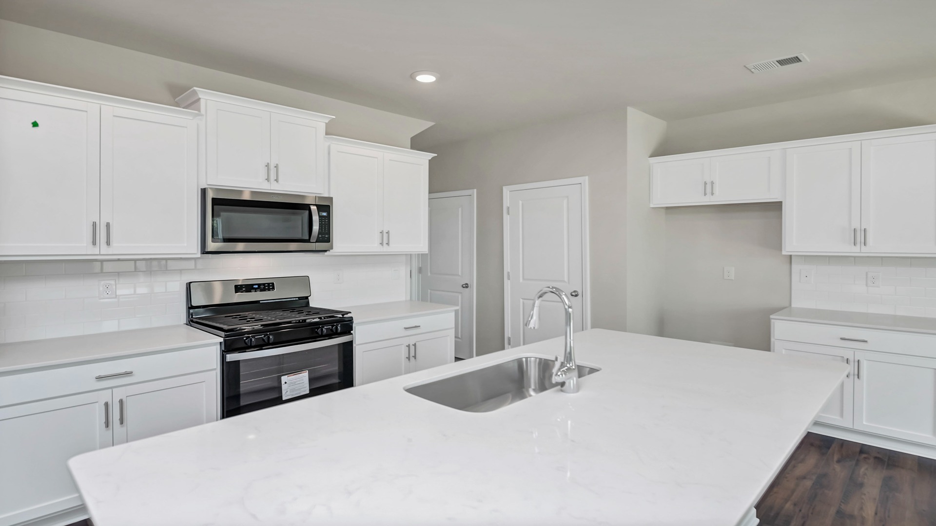 Aisle kitchen with white quartz countertops
