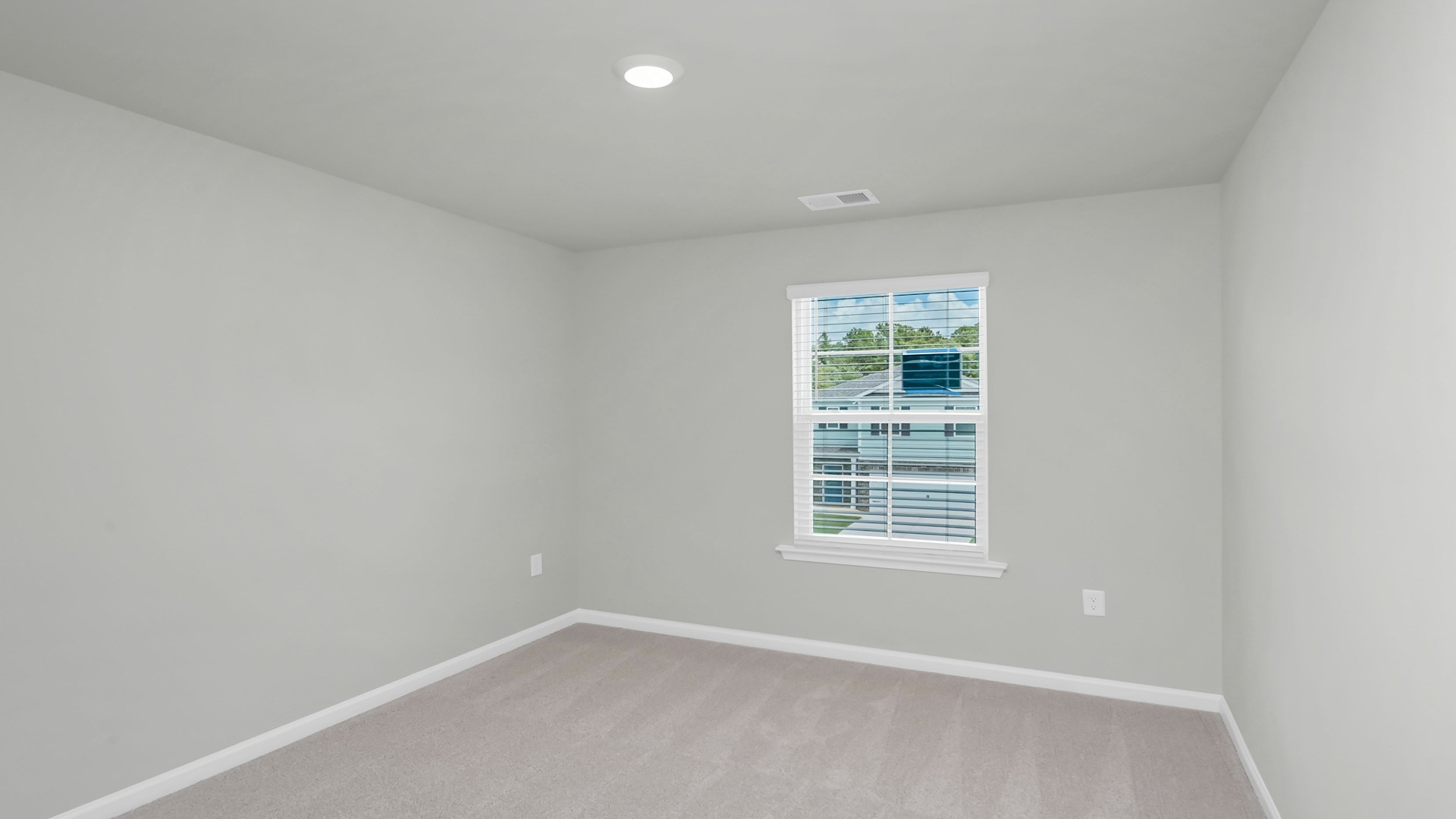 Bedroom 2 upstairs with a window and carpet floors