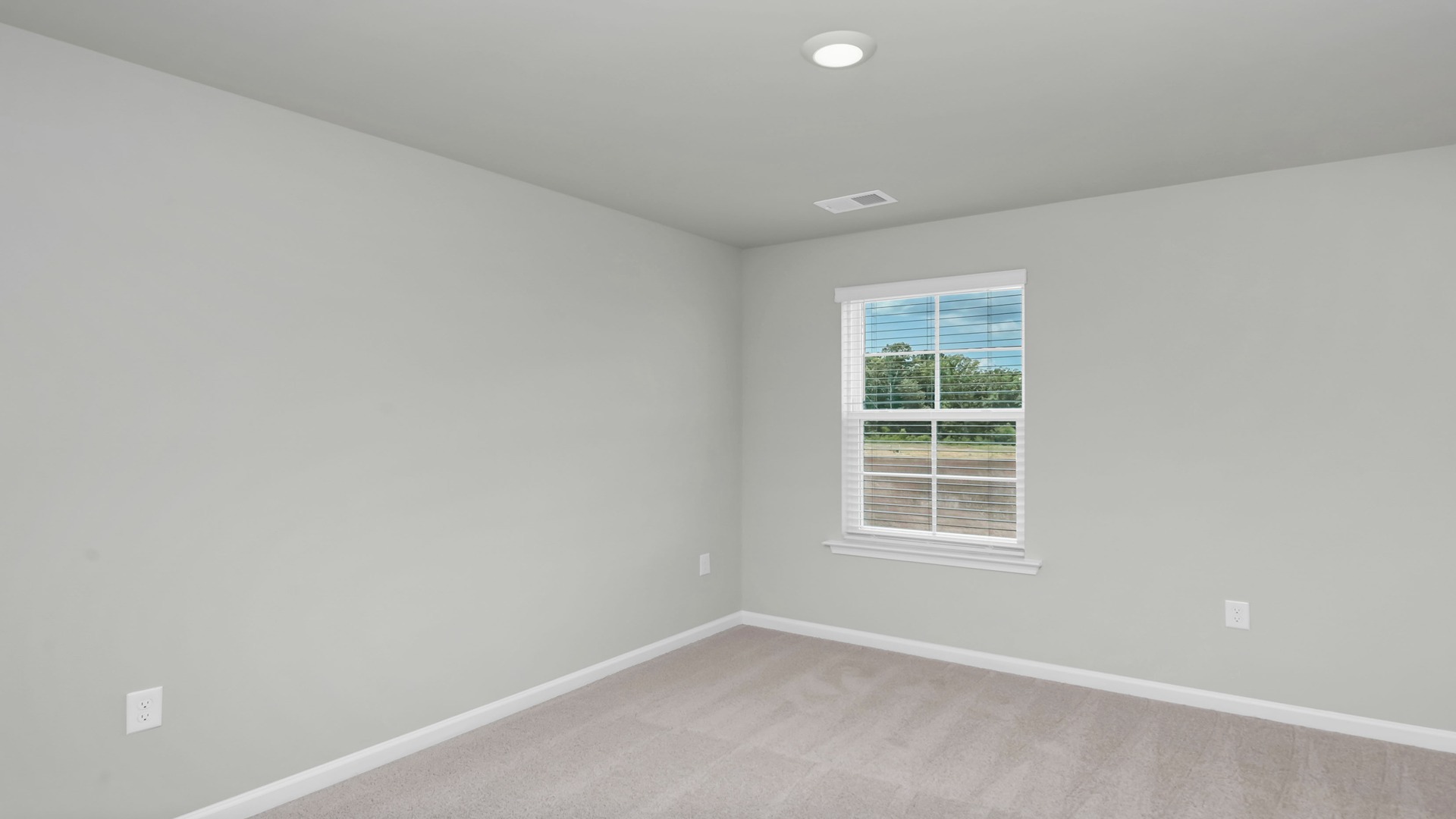 Bedroom 4 in the Aisle with plush carpet and a window