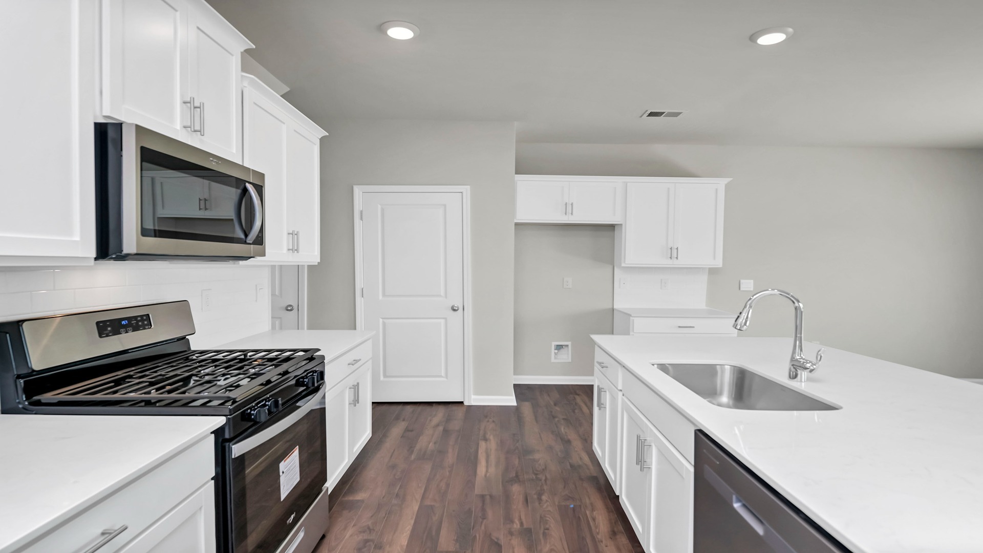 Sleek, white quartz countertops in the kitchen space