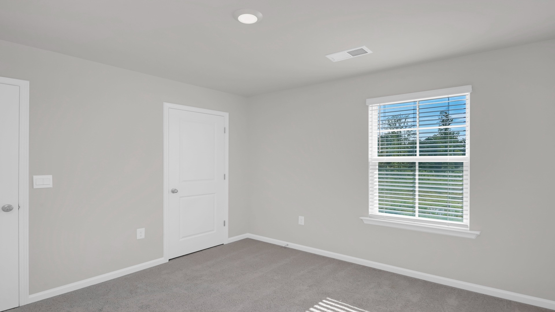 Bedroom 4 with carpet flooring and a window for light