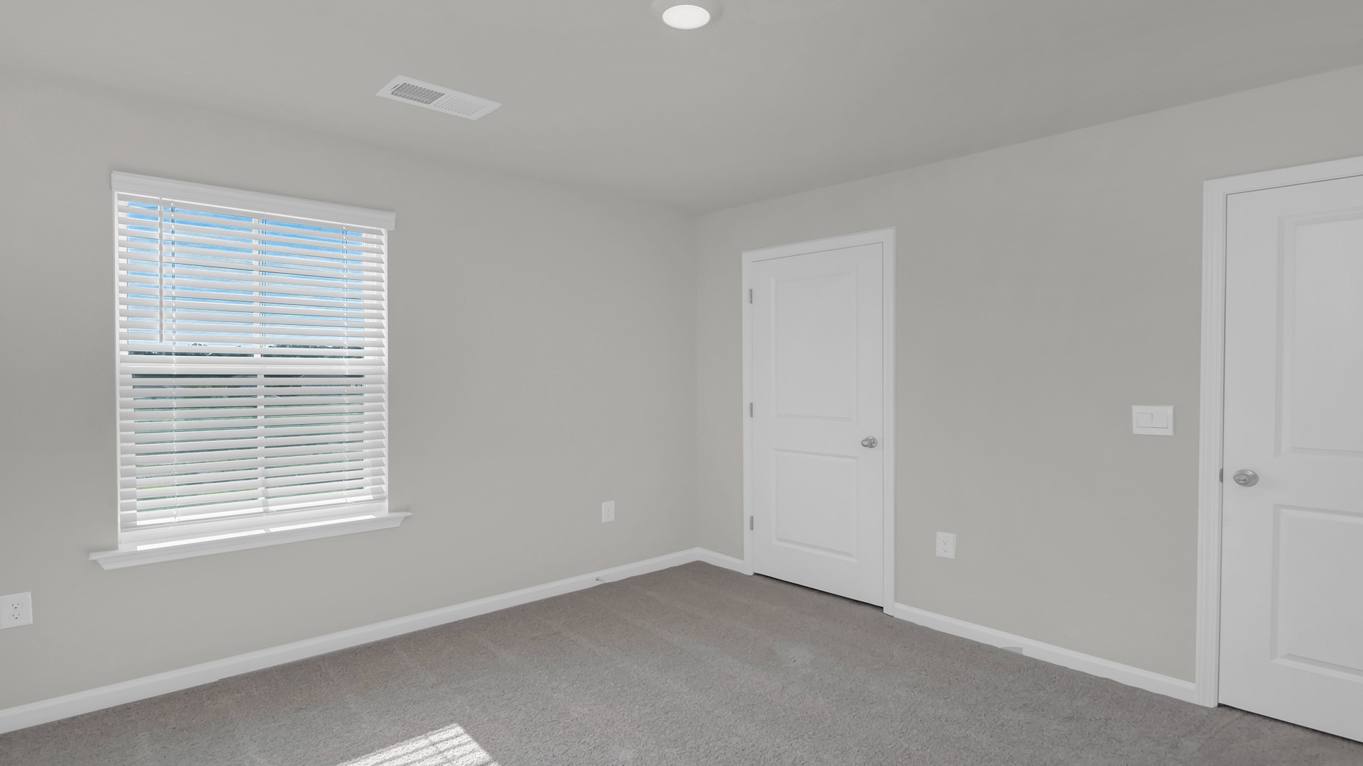 Bedroom 5 with carpet flooring and a window for light