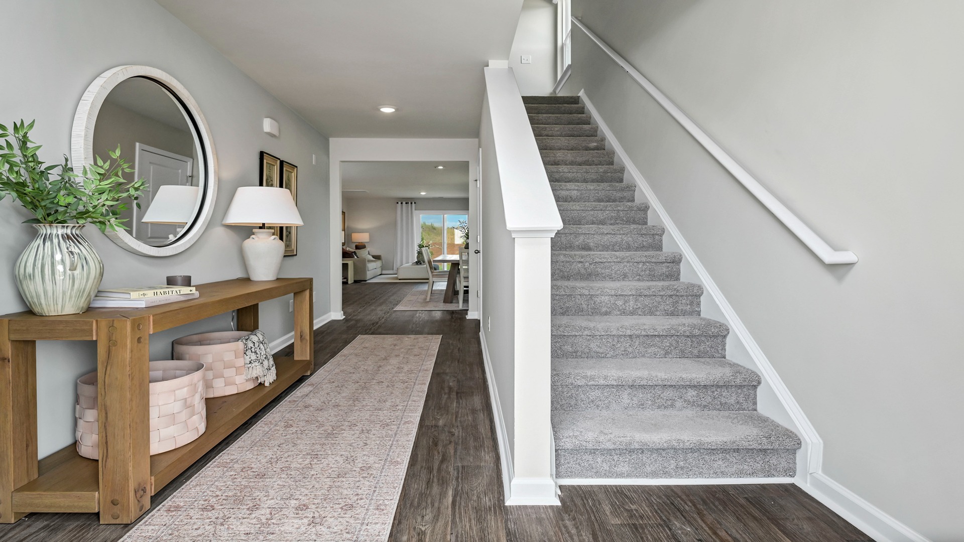 Carpeted stairs in the front foyer leads to second floor of Robie floorplan in Ferry Grove