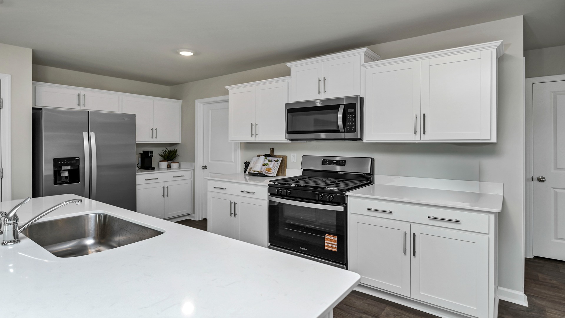 Sleek, white quartz countertops finish the kitchens of homes for sale in Ferry Grove