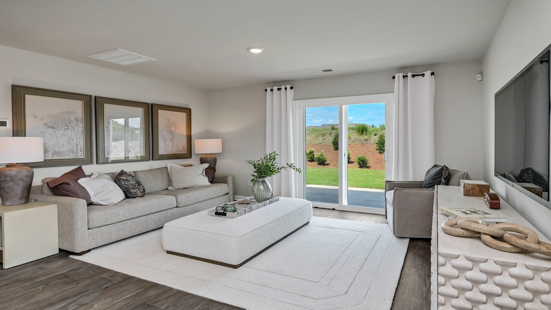 Sliding glass doors in the living area lead out to the paved back patio of the Robie in Ferry Grove