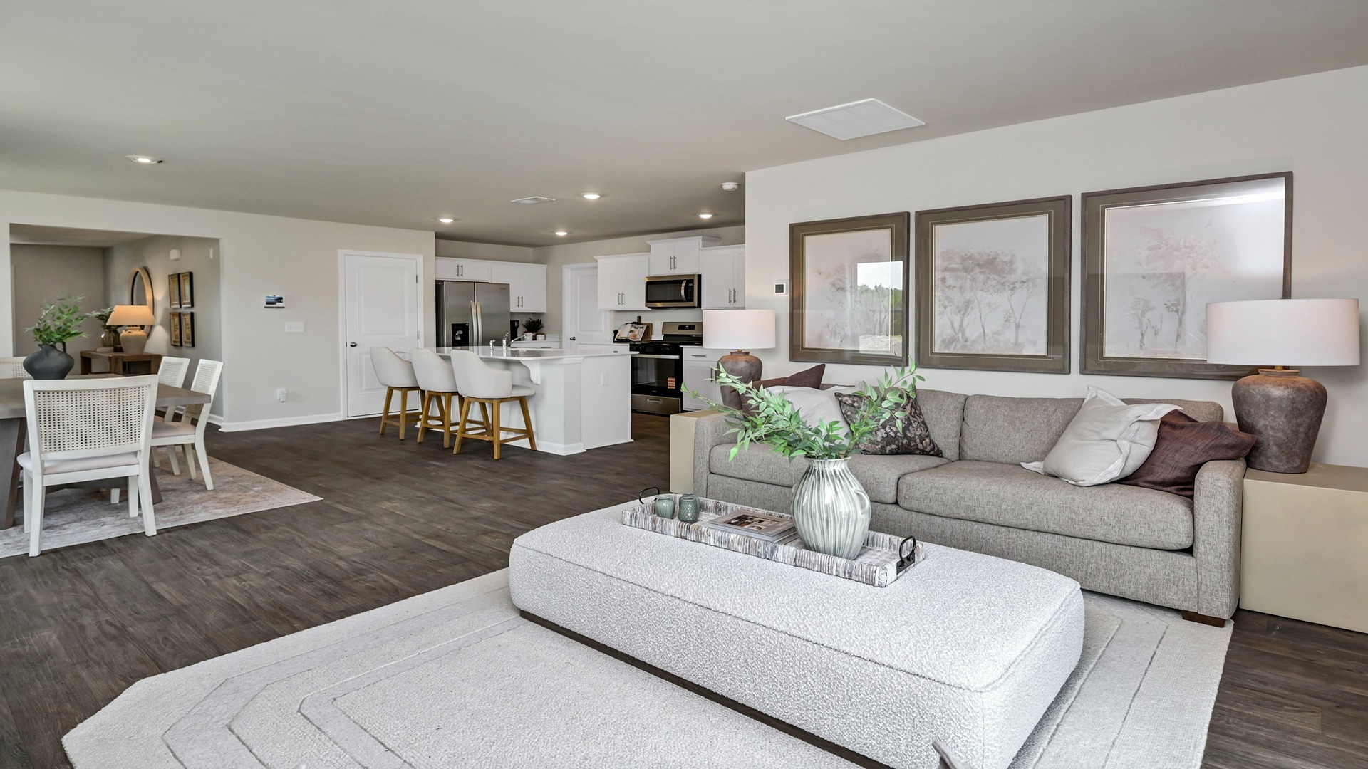 The living area of the Robie floorplan in Ferry Grove seamlessly connects to the open dining and kitchen areas