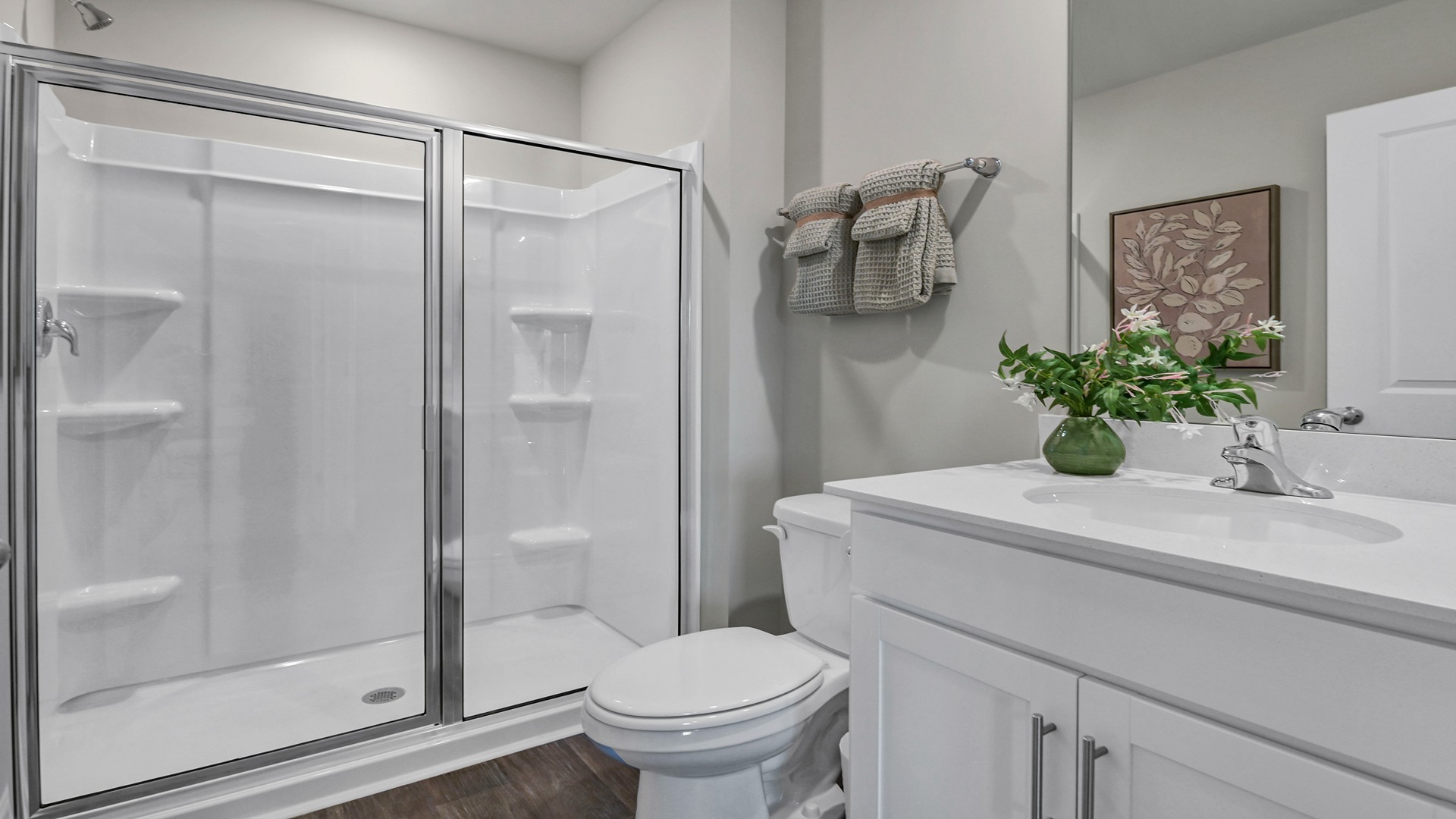 Full downstairs bathroom with a standup shower and single-sink vanity