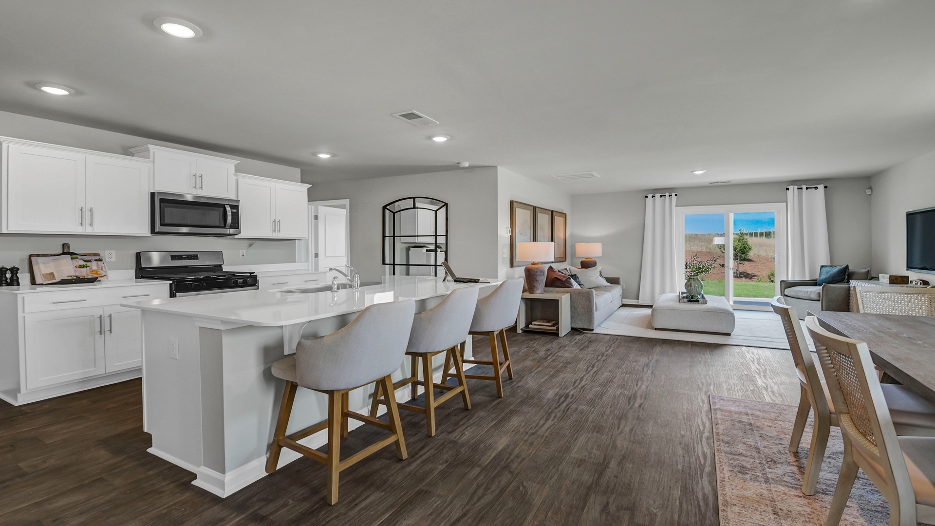 Open concept kitchen, dining, and living areas on the first floor of the Robie floorplan in Ferry Grove