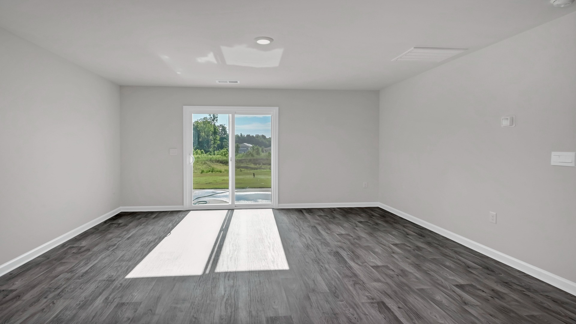 The sliding glass door in the living area leads to the back patio