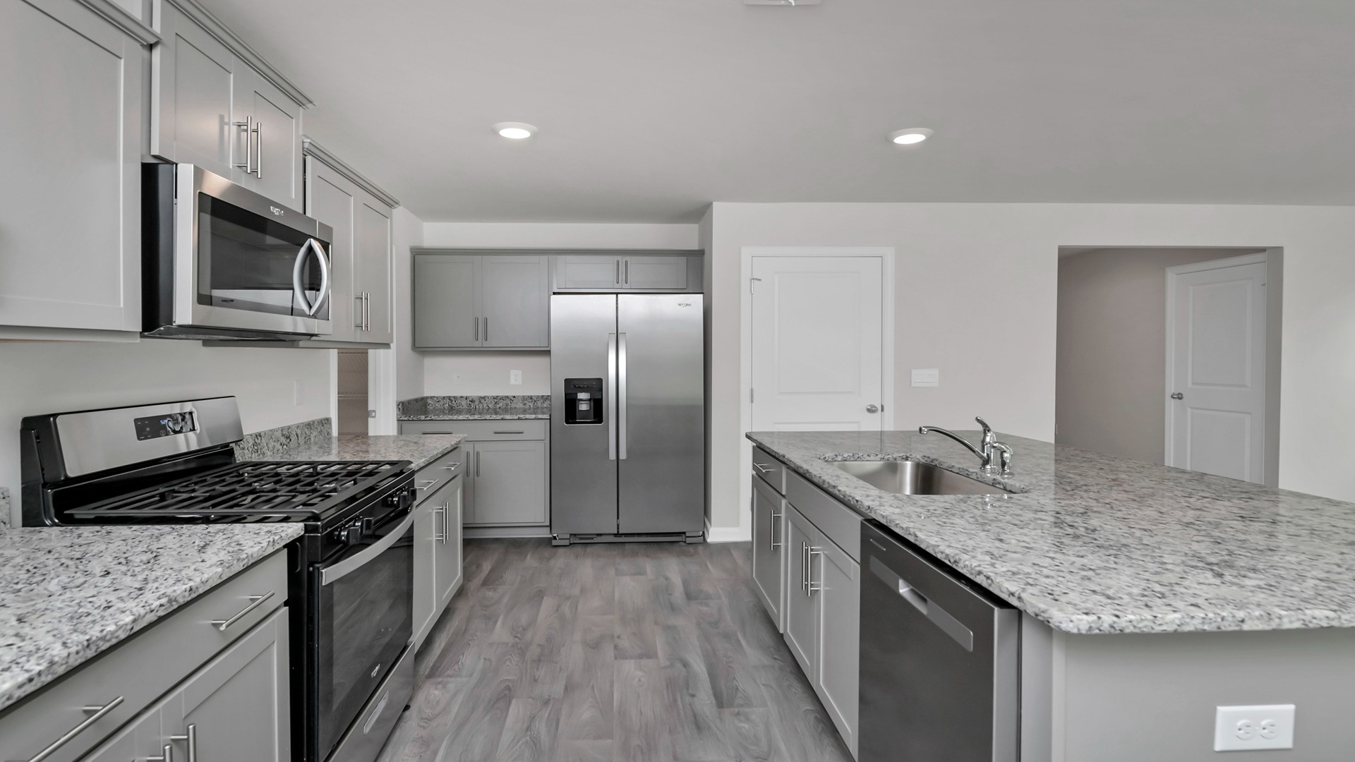 Granite countertops are pictured, but this community will feature quartz countertops