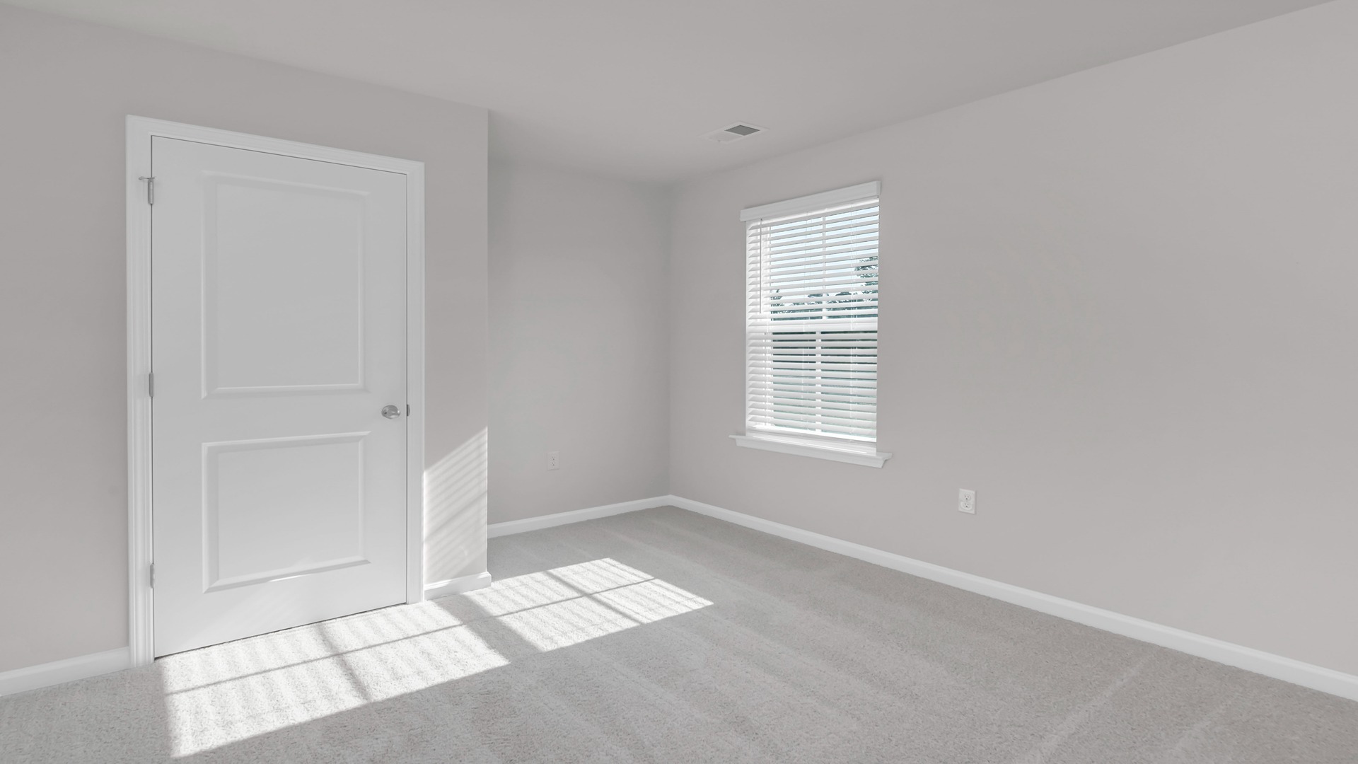 Bedroom 2 is downstairs with carpet flooring and a window