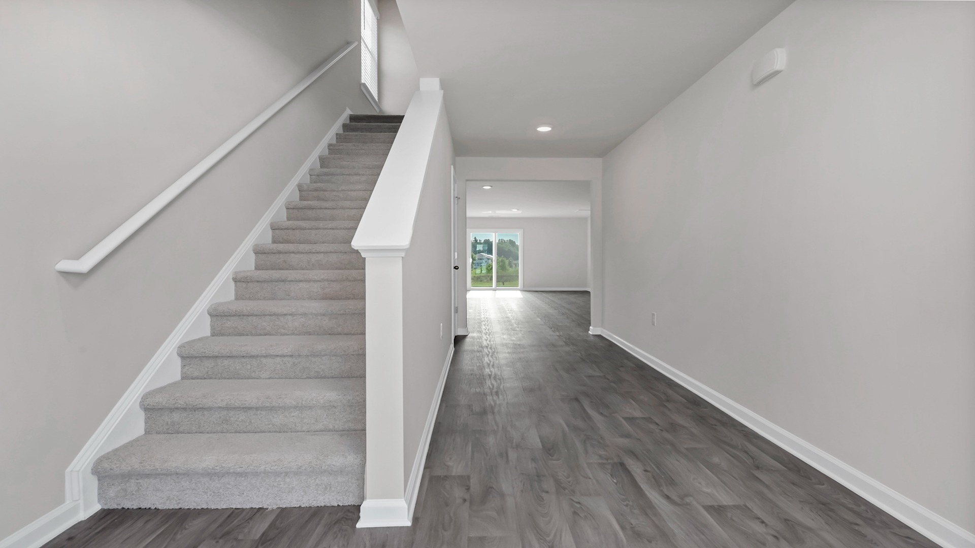 The stairway to upstairs is off the front foyer